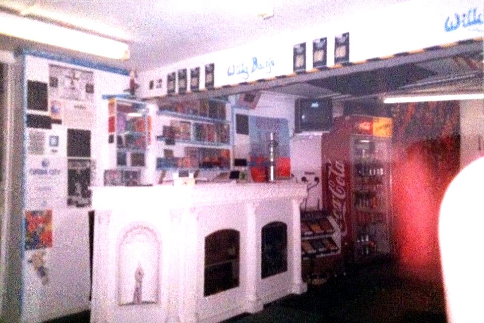 Willy Banjo shop interior — bar counter with Coke fridge and changing room