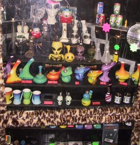 Willy Banjo basement shop in the 1990s, shelves of alien bongs and ceramic pipes with leopard print trim