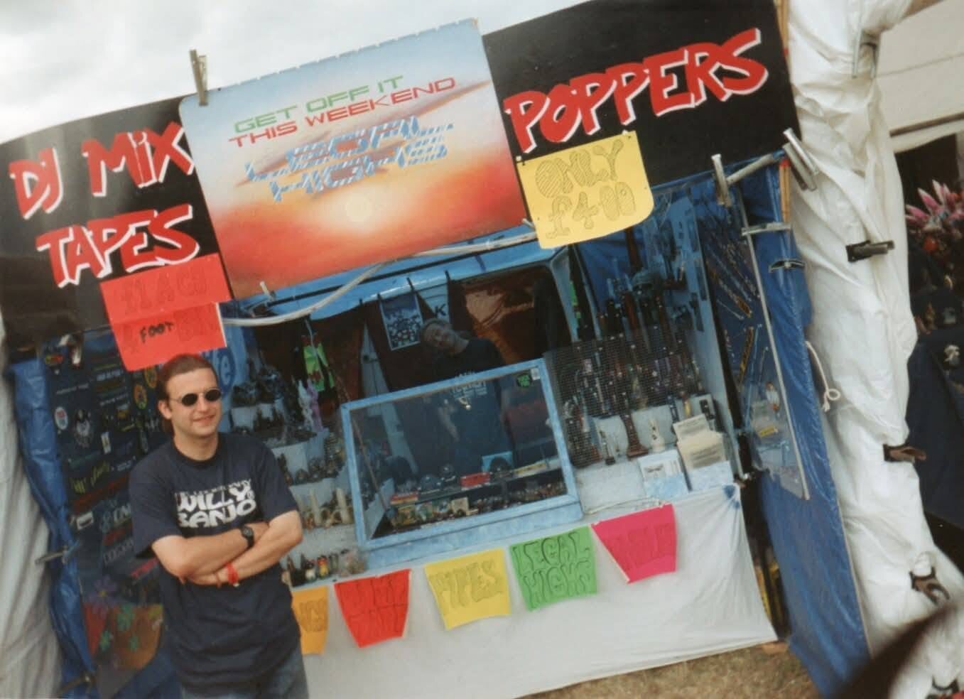 The first ever Willy Banjo festival stall with hand-painted signs for DJ mix tapes and poppers