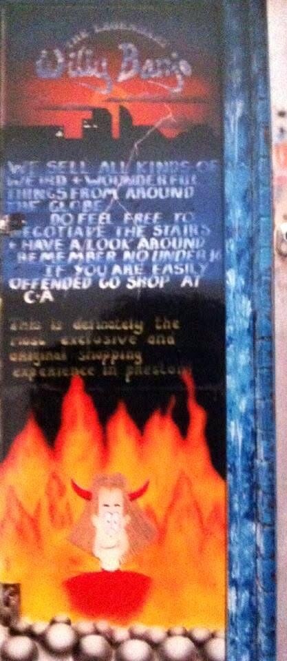 The original hand-painted Willy Banjo door sign reading we sell all kinds of weird and wonderful things from around the globe