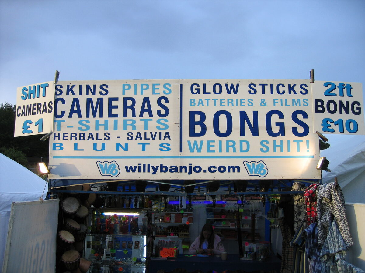 Willy Banjo stall signage at dusk, skins, pipes, bongs and weird shit