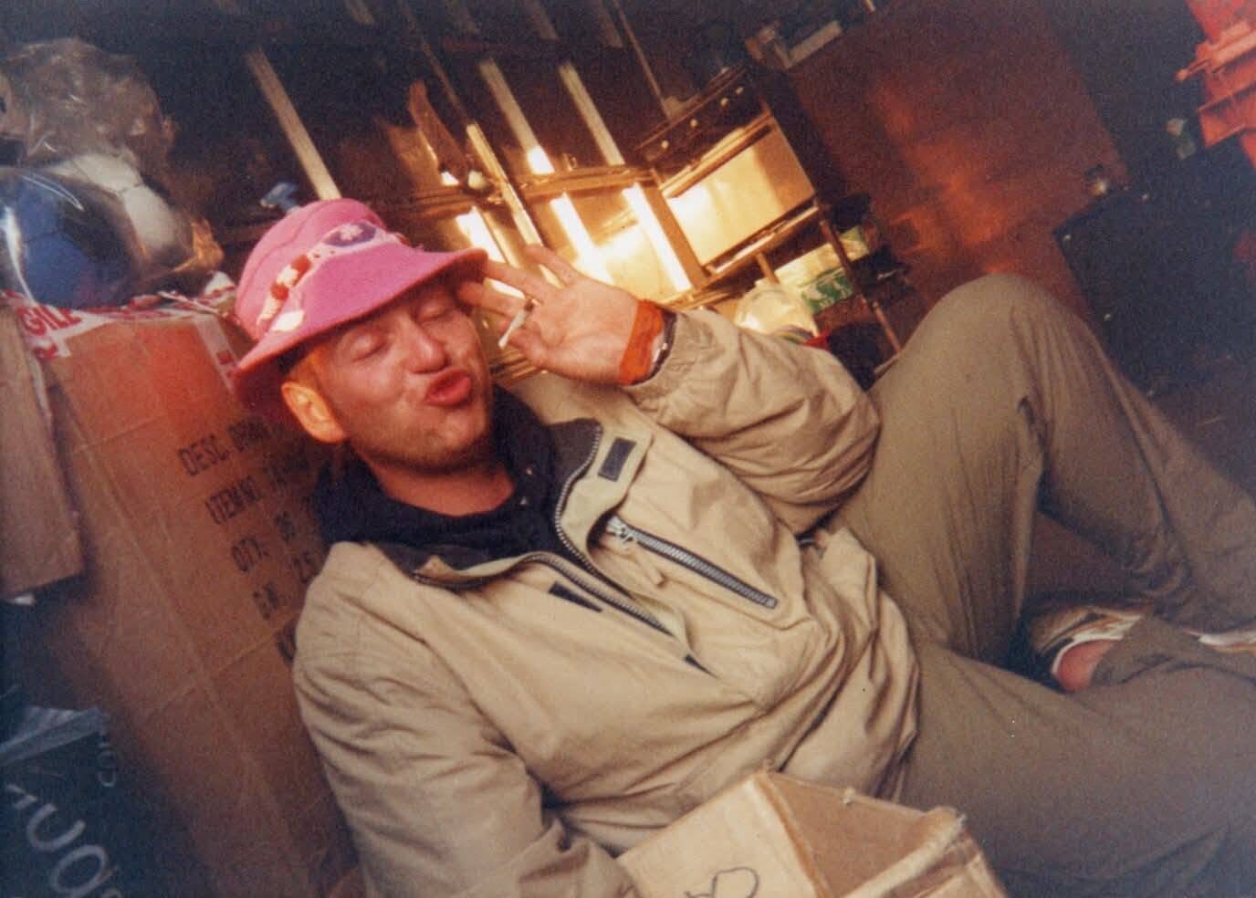 Big Bad Bob in a pink bucket hat among stock boxes at a festival