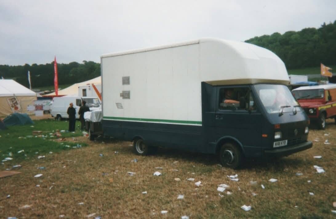 Willy Banjo VW LT box van in a litter-strewn festival field at pack-down