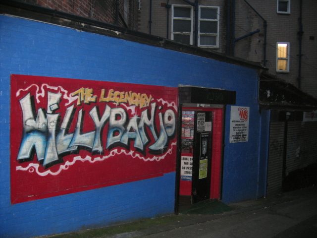 The Legendary Willy Banjo red and chrome graffiti panel by Baron on a blue wall