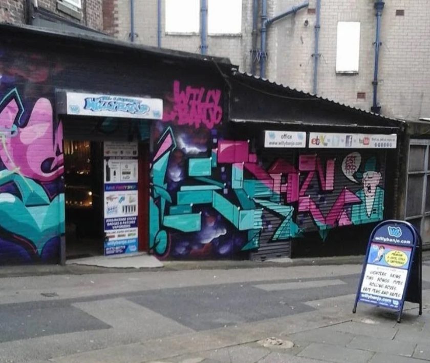 Teal and pink graffiti across the Willy Banjo shop front