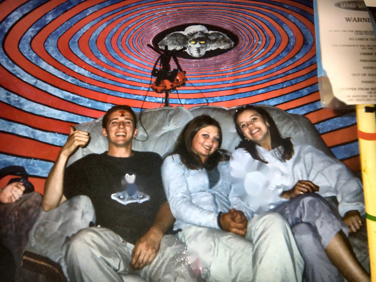 Three people on the Mind Machine sofa under the red and blue spiral